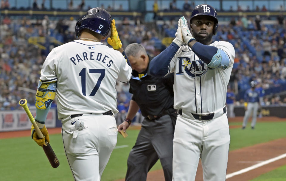 Tampa Bay Rays' Isaac Paredes (17) and Randy Arozarena celebrate Arozarena's solo home run off Toronto Blue Jays starter Yusei Kikuchi during the fifth inning of a baseball game, Saturday, March 30, 2024, in St. Petersburg, Fla. (AP Photo/Steve Nesius)