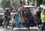 Residents evacuate as Taal Volcano erupts Sunday Jan. 12, 2020, in Tagaytay, Cavite province, outside Manila, Philippines. A tiny volcano near the Philippine capital that draws many tourists for its picturesque setting in a lake belched steam, ash and rocks in a huge plume Sunday, prompting thousands of residents to flee and officials to temporarily suspend flights. (AP Photo/Aaron Favila)