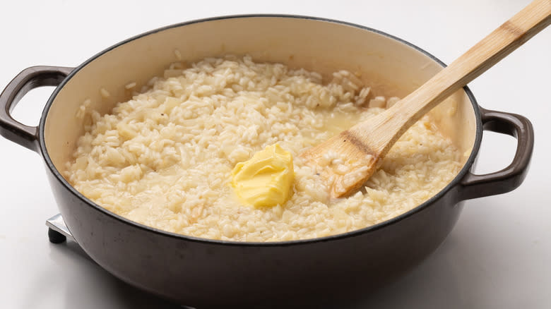 stirring butter into risotto