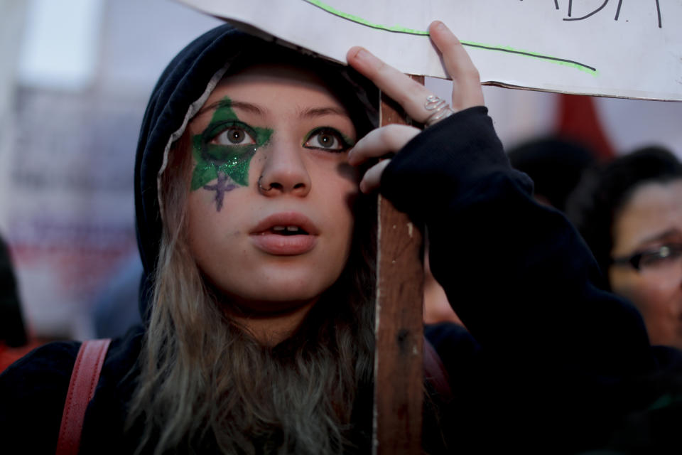 <p>A demonstrator in support of decriminalizing abortion watches live images of lawmakers debating the issue, outside Congress in Buenos Aires, Argentina, Wednesday, Aug. 8, 2018. Following months of increasingly tense debate, lawmakers are meeting on Wednesday ahead of a vote on a bill that would decriminalize abortions up to the first 14 weeks of pregnancy. (AP Photo/Natacha Pisarenko) </p>