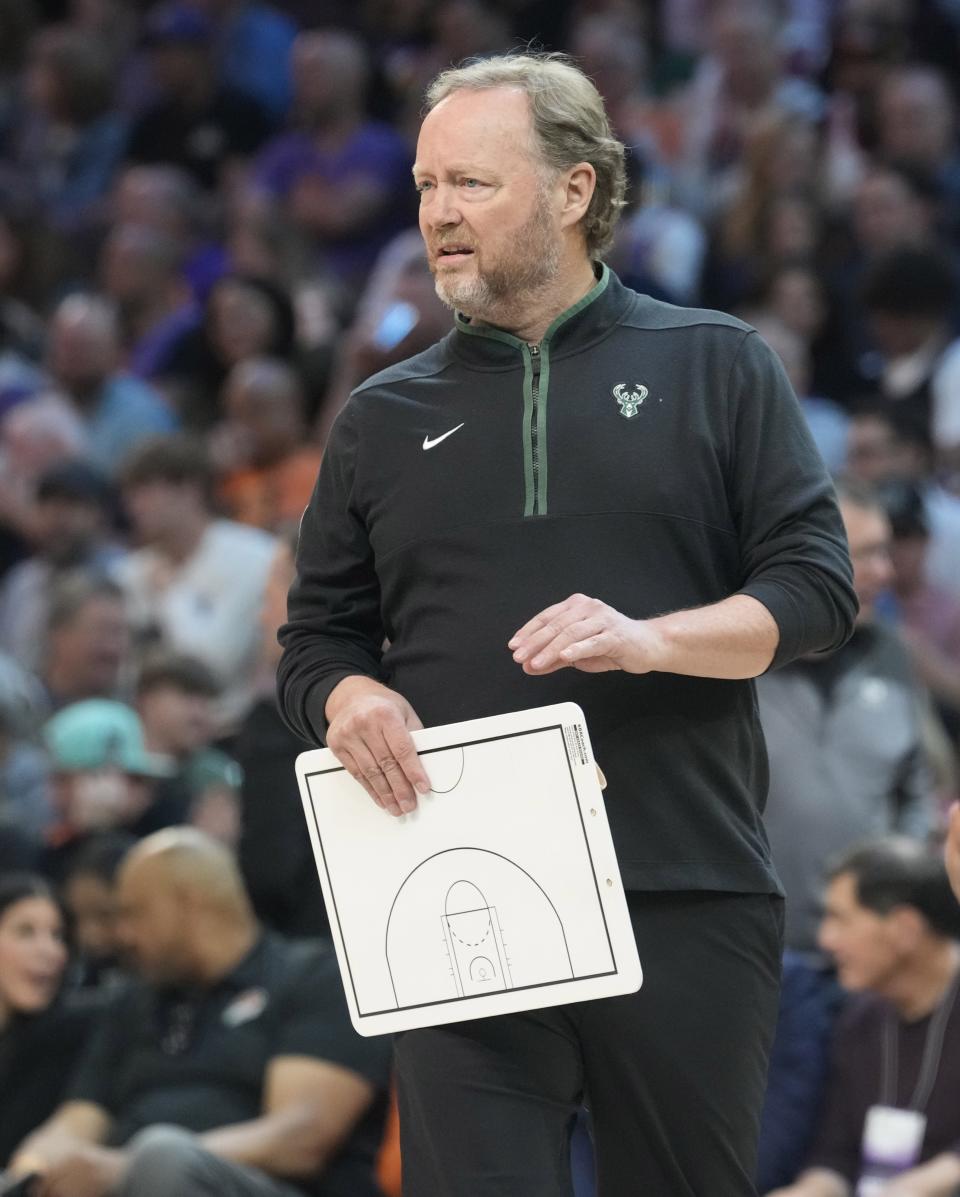 Milwaukee Bucks head coach Mike Budenholzer holds a clipboard during a timeout during the first quarter against the Phoenix Suns at Footprint Center in Phoenix on March 14, 2023.