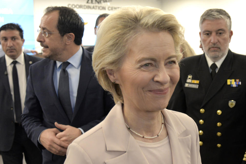 President of the European Commission, Ursula von Der Leyen smiles as she walks with Cypriot President Nikos Christodoulides, rear left, after a press conference at the Joint Search and Rescue Coordination center in Larnaca, Cyprus, on Friday, March 8, 2024. Von der Leyen is in Cyprus to inspect facilities at the port of Larnaca from where it's hoped ships will soon start departing for Gaza to deliver aid amid growing international support for the Cypriot initiative to establish a maritime humanitarian corridor to the Palestinian enclave some 240 miles (386 kilometers) away. (AP Photo/Marcos Andronicou)