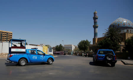 Iraqi police vehicles drive past al-Firdous square, where the statue of Saddam Hussein was pulled down by U.S. Marines on April 9, 2003, in Baghdad, Iraq April 8, 2018. REUTERS/Khalid al Mousily