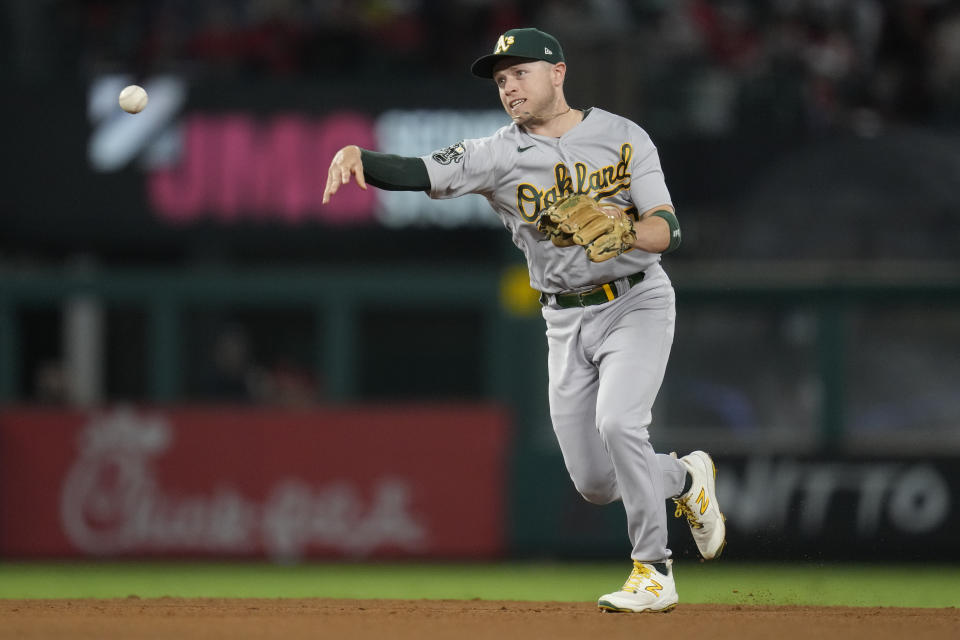 Oakland Athletics shortstop Nick Allen (2) throws to first to out Los Angeles Angels' Mickey Moniak during the sixth inning of a baseball game in Anaheim, Calif., Saturday, Sept. 30, 2023. (AP Photo/Ashley Landis)