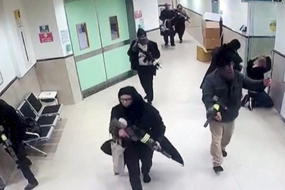 In this image taken from surveillance video provided by the Palestinian Health Ministry, Israeli forces disguised as civilian women and medical workers hold weapons in a hallway at the Ibn Sina Hospital in the West Bank town of Jenin, Tuesday, jan 30, 2024, in the occupied West Bank, killing three Palestinian militants in a dramatic raid that underscored how deadly violence has spilled into the territory from the war in Gaza. (Palestinian Health Ministry via AP)