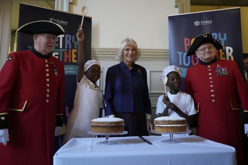 The Duchess of Cornwall, centre, with children and Chelsea Pensioners during the recital (Frank Augstein/PA) (PA Wire)