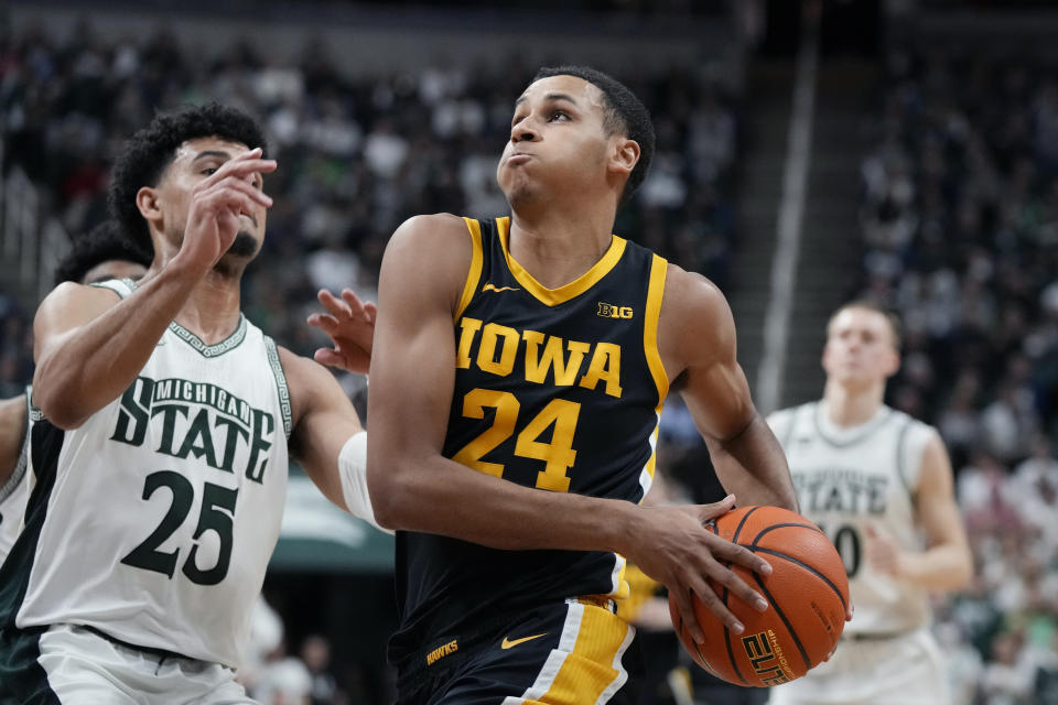 Iowa forward Kris Murray (24) attempts a layup as Michigan State forward Malik Hall (25) defends during the first half of an NCAA college basketball game, Thursday, Jan. 26, 2023, in East Lansing, Mich. (AP Photo/Carlos Osorio)