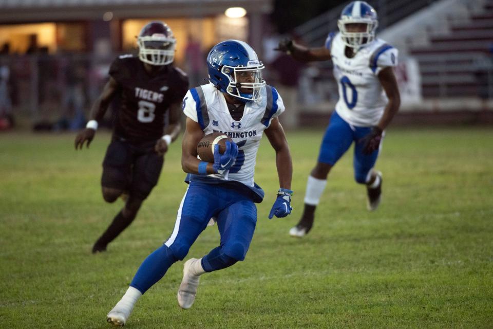 Washington's Kyler Battle (No. 6) cuts back to the center of the field as he looks for room to run during Friday night's regular-season opener against Pensacola High School.