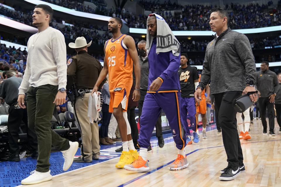 Phoenix Suns forward Mikal Bridges (25) and guard Chris Paul, second from right, walk off the court after Game 4 of an NBA basketball second-round playoff series against the Dallas Mavericks, Sunday, May 8, 2022, in Dallas. (AP Photo/Tony Gutierrez)