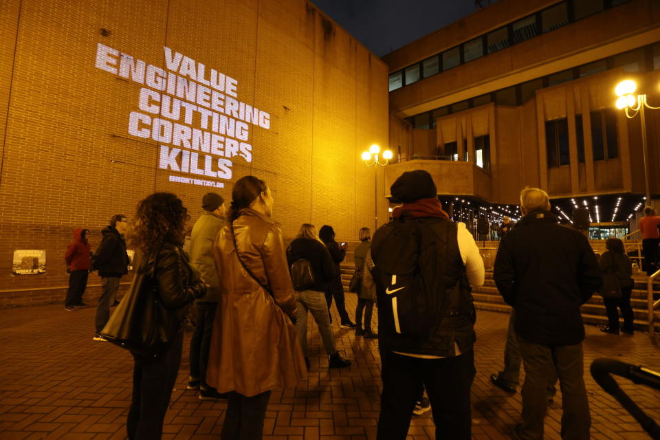 People attend a rally outside Kensington Town Hall to bring attention to the lack of support and action over the Grenfell Tower fire, in London, Sunday Nov. 14, 2021. In 2017 a small kitchen fire in the west London public-housing block turned into the worst domestic blaze in the country since World War II. (James Manning/PA via AP)