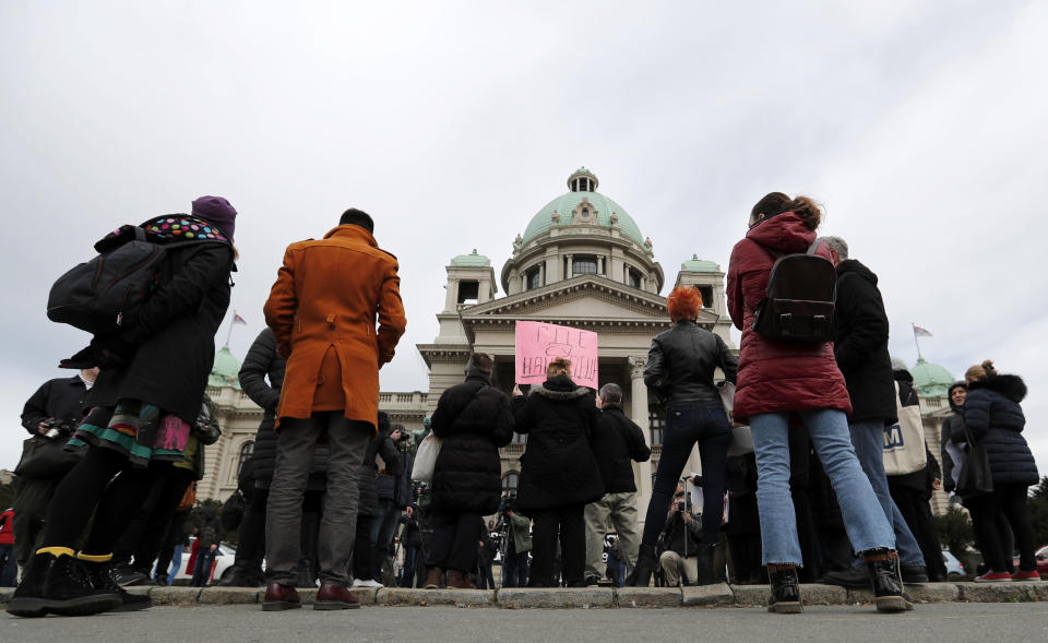 In this photo taken Monday, Feb. 24, 2020, a participant holds a banner that reads: "Where are our Children", during a protest in front of the parliament building in Belgrade, Serbia. After years of waiting, Serbian lawmakers are set to soon pass a bill that authorities say attempts to shed light on a chilling, decades-old scandal involving hundreds of families who suspect their babies were stolen at birth. (AP Photo/Darko Vojinovic)