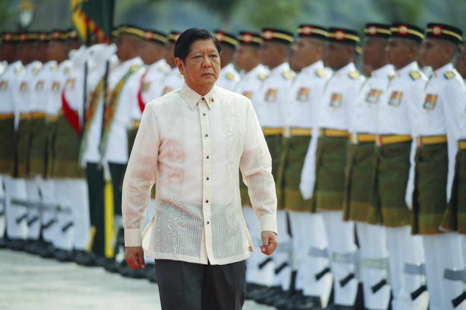 Philippine President Ferdinand Marcos Jr., right, inspects the Royal Malay Regiment guard of honor during the state welcome ceremony at National Palace in Kuala Lumpur, Malaysia Wednesday, July 26, 2023. (Fazry Ismail/Pool Photo via AP)