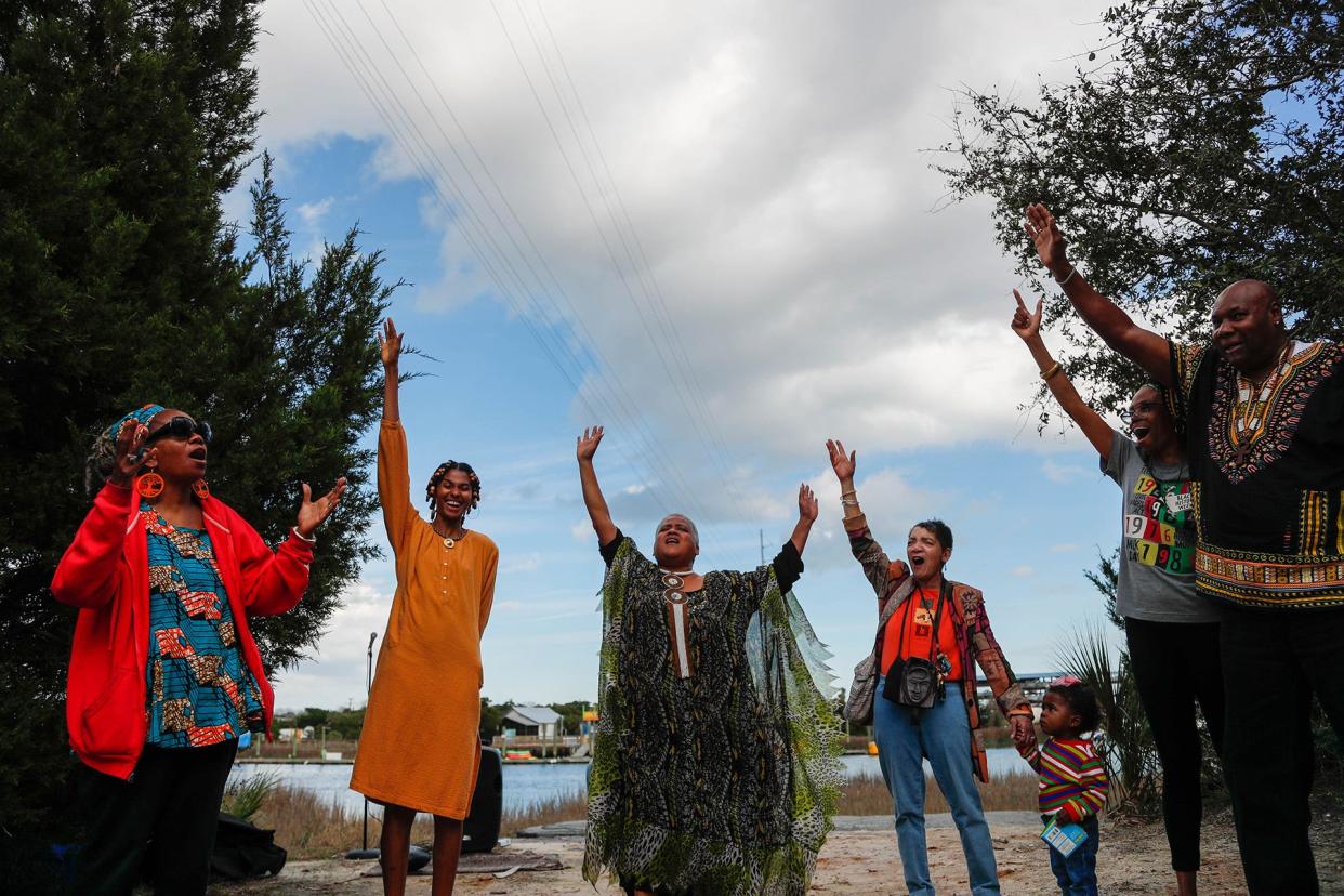 Lillian Grant-Baptiste, center, leads a chant of "Harambe", which according to Grant-Baptiste means 'let's pull together', as they close out a libation ceremony on the first day of the 34th annual Savannah Black Heritage Festival on Wednesday February 1, 2023 near the Lazaretto Creek Boat Ramp.