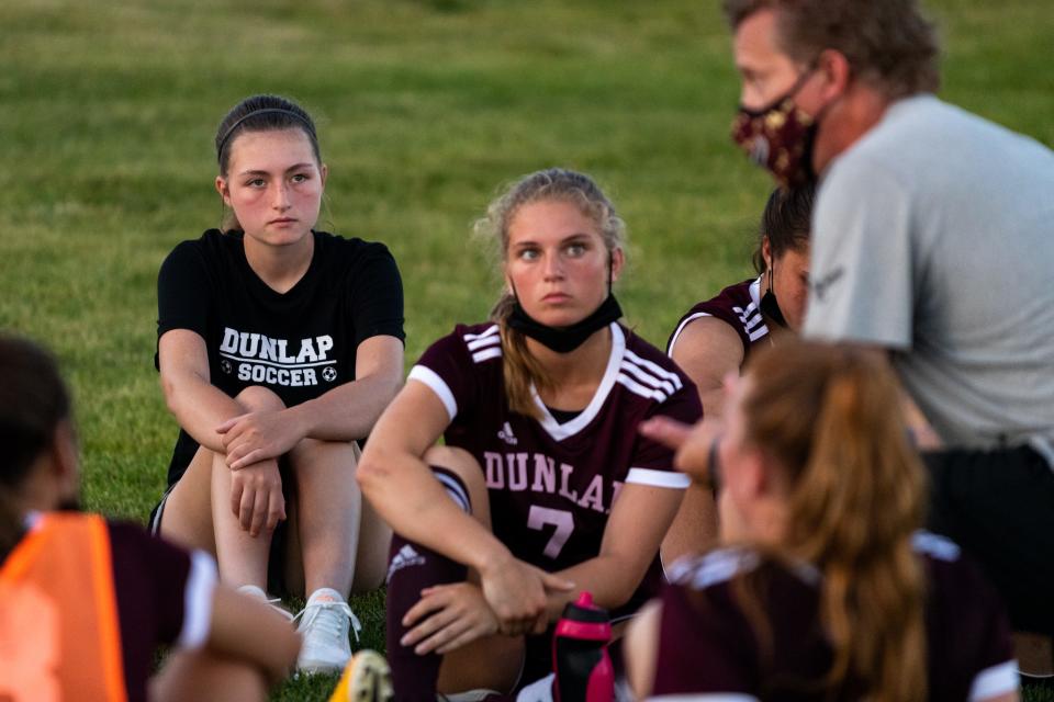 Tessa Sutton (back left) listens to Dunlap coach Peter Cenek during a game last season. Sutton was diagnosed with cancer last year and ended treatments in March. Last month, the cancer was rediscovered — and the Peoria-area soccer community is showing its support.