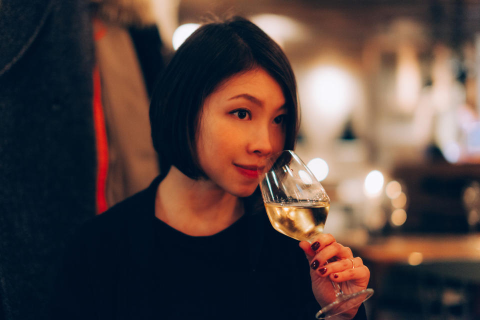 woman taking a sip of wine