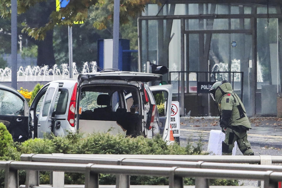 A bomb disposal expert works next to a car after an explosion in Ankara, Sunday, Oct. 1, 2023. A suicide bomber detonated an explosive device in the heart of the Turkish capital, Ankara, on Sunday A second assailant was killed in a shootout with police, the interior minister said. (Yavuz Ozden/Dia Images via AP)