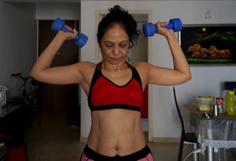 Geeta J exercises with dumbbells inside her house in Mumbai