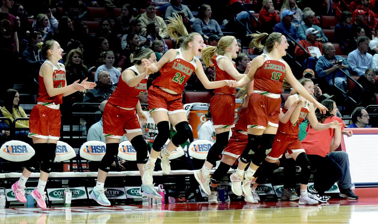 Lincoln girls basketball players celebrate their win over Glenwood at the Girls Class 3A Basketball State Championship at the CEFCU Arena Saturday, March 2, 2024.