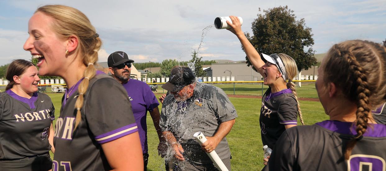 North Kitsap softball coach Clay Blackwood gets a celebratory drenching by Anna Wetzsteon after their Class 2A title game 8-1 win over Ridgefield at Carlon Park in Selah on Saturday, May 27, 2023. 