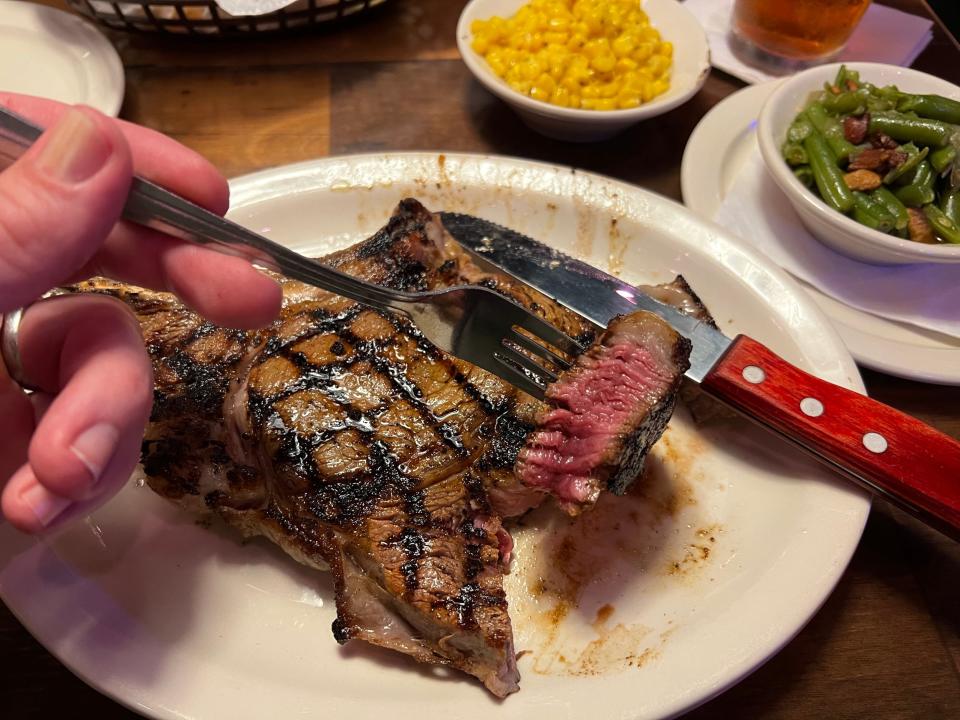 A bone-in ribeye cooked medium-rare at a Texas Roadhouse