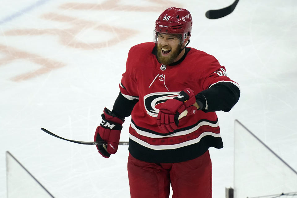 Carolina Hurricanes defenseman Jani Hakanpaa (58) reacts following his game-winning goal against the Nashville Predators during the third period of an NHL hockey game in Raleigh, N.C., Saturday, April 17, 2021. (AP Photo/Gerry Broome)