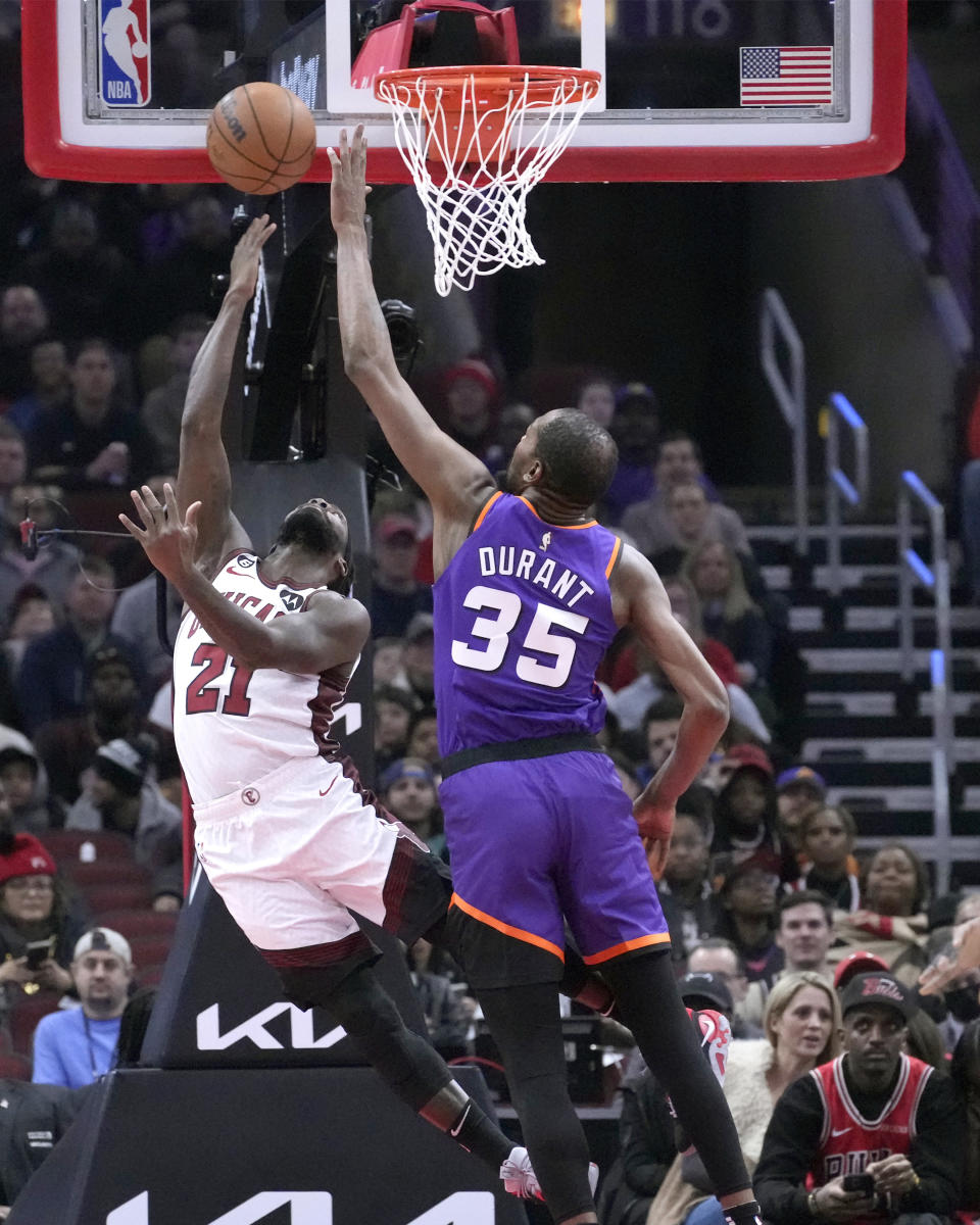 Chicago Bulls' Patrick Beverley (21) scores past Phoenix Suns' Kevin Durant during the first half of an NBA basketball game Friday, March 3, 2023, in Chicago. (AP Photo/Charles Rex Arbogast)