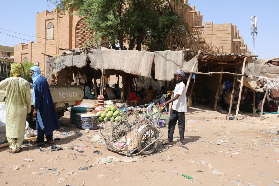 Men stand in the streets of Timbuktu, Mali, Sunday Sept. 26, 2021. Many residents of Timbuktu are worried that when French troops pull out of the city in northern Mali, jihadis will return to impose strict Shariah law including public whippings and amputations. The Islamic extremists ruled Timbuktu in 2012 and banned music, sports and destroyed historic mausoleums, saying they were idolatrous. (AP Photo/Moulaye Sayah)