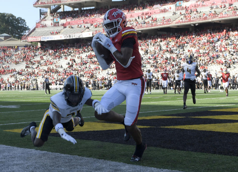 Maryland wide receiver Kaden Prather (1) catches a touchdown against Towson defensive back Shafeek Smith (31) in the first half of an NCAA football game Saturday, Sept. 2, 2023 in College Park, Md. (AP Photo/Steve Ruark)