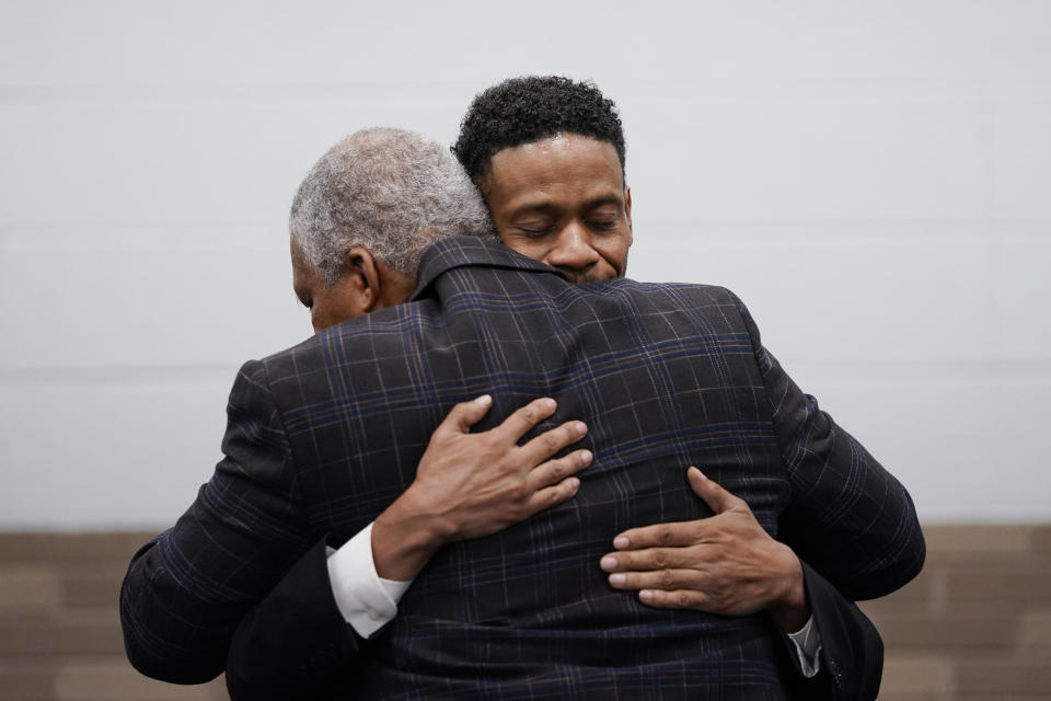 Aretha Franklin's sons Kecalf Franklin, rear, hugs Edward Franklin after a ceremony honoring Aretha Franklin, Monday, Oct. 4, 2021, in Detroit. Five years after her death, the final wishes of the music superstar are still unsettled. The latest: an unusual trial next Monday to determine which handwritten will, including one found in couch cushions, will guide how her estate is handled. The dispute is putting a son against other sons. Ted White II believes papers dated in 2010 should mainly control the estate while Kecalf and Edward favor a 2014 document. (AP Photo/Carlos Osorio_File)