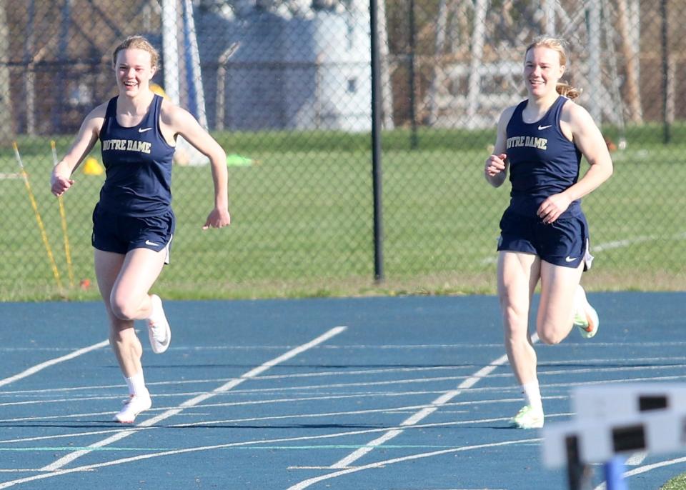 Elmira Notre Dame sisters Rachael Simpson, left, and Amanda Simpson share a laugh as they compete in the 200-meter dash in an IAC meet against Watkins Glen on April 20, 2022 at the Molly Huddle Track & Field Complex at Notre Dame High School.