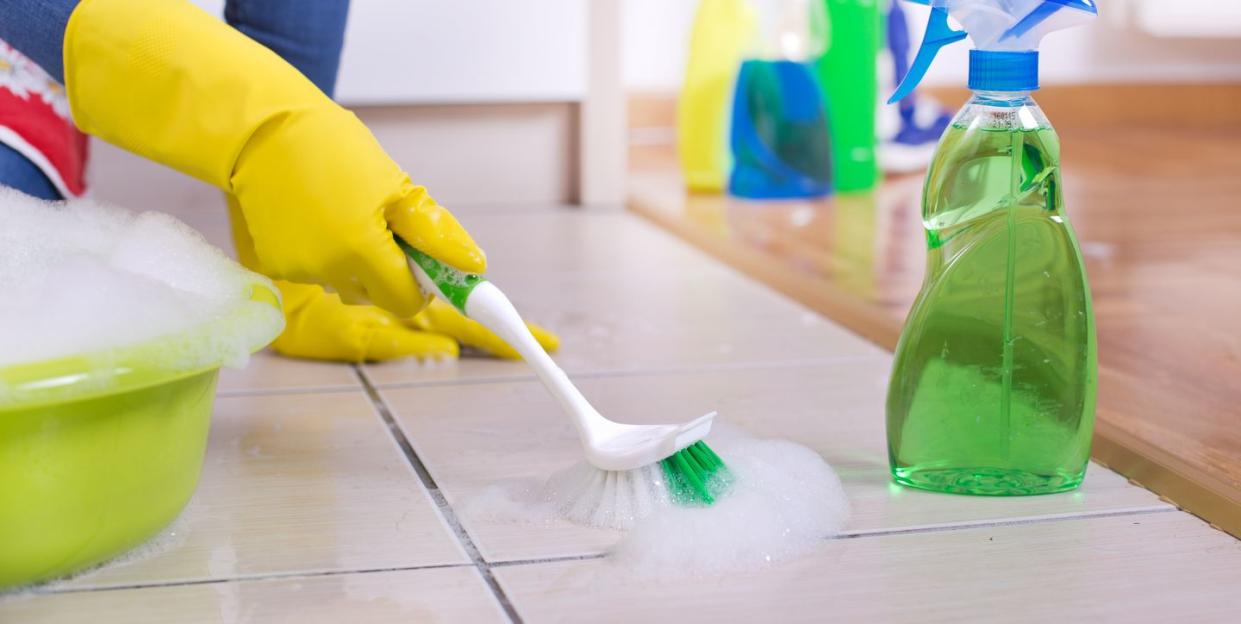 woman cleaning kitchen floor