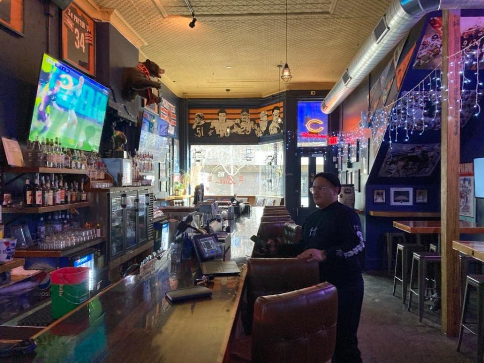 Isaac Alaniz, an owner, stands inside the Chicago Bears-themed 85 Bar before opening time in the East Village in Des Moines.