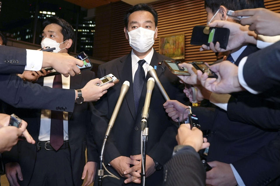 Japan's Economy Minister Daishiro Yamagiwa is surrounded by reporters at the prime minister's official residence in Tokyo, Monday, Oct. 24, 2022. Yamagiwa on Monday said he submitted his resignation to Prime Minister Fumio Kishdia over his ties to the Unification Church after facing mounting criticisms that he lacked explanations in a widening controversy that has involved dozens of other party lawmakers and rocked Kishida’s government.(Kyodo News via AP)