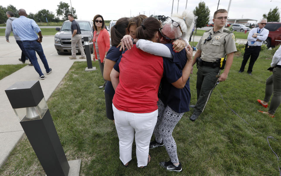 Friends and family of missing University of Iowa student Mollie Tibbetts react following a news conference, Tuesday, Aug. 21, 2018, in Montezuma, Iowa. Police say a man in the country illegally has been charged with murder in the death of Tibbetts who was reported missing from her hometown in the eastern Iowa city of Brooklyn in July 2018. (AP Photo/Charlie Neibergall)