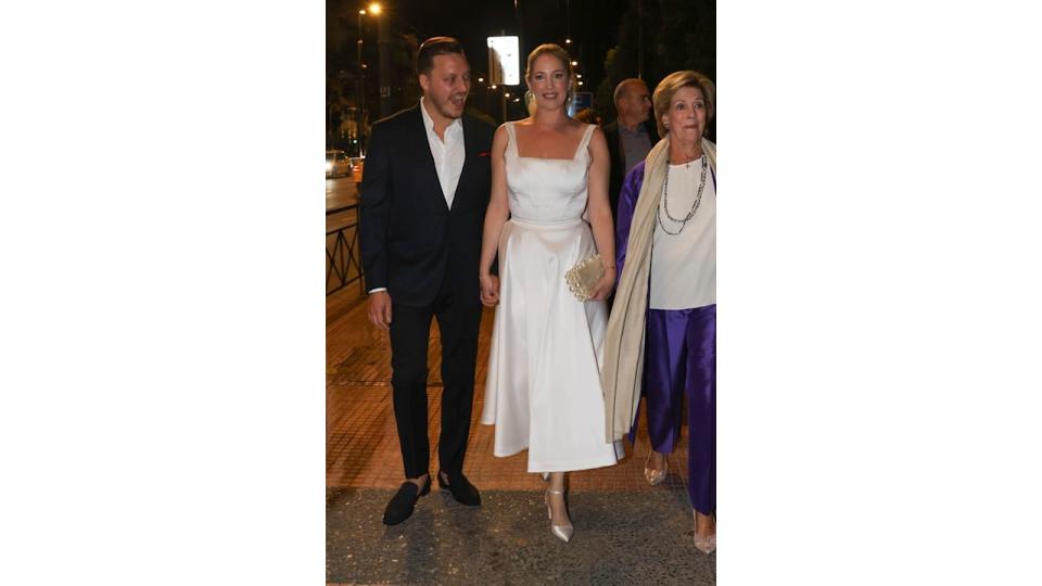 Matthew Kumar holding the hand of Princess Theodora as they walk with Queen Anne-Marie