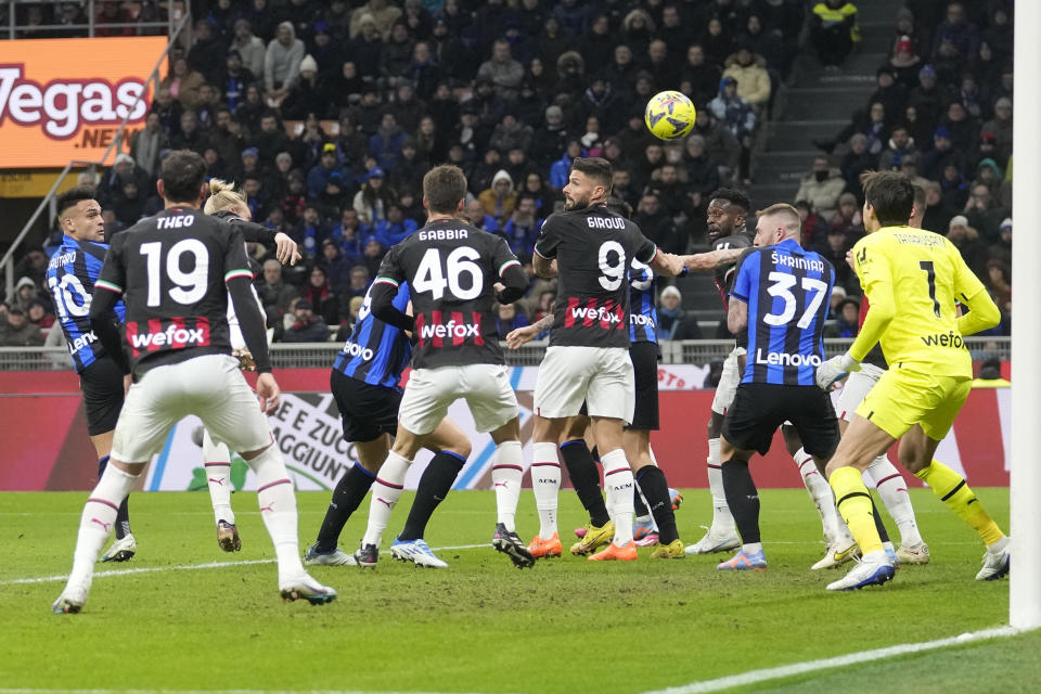 Inter Milan's Lautaro Martinez, left, scores his side's opening goal during the Serie A soccer match between Inter Milan and AC Milan at the San Siro Stadium, in Milan, Italy, Sunday, Feb. 5, 2023. (AP Photo/Antonio Calanni)