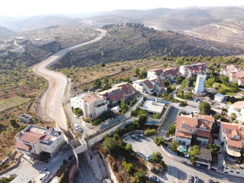 An aerial photo shows Sa'adat Gharib's family home, surrounded by a high security fence in the middle of an Israeli settlement in East Jerusalem, Nov. 9, 2023. / Credit: CBS News