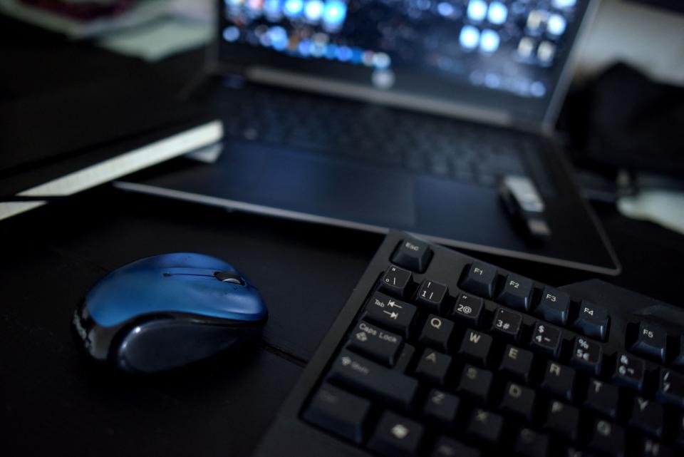 A home office desk set up with a keyboard, a mouse and a laptop pictured in Los Angeles, Calif.