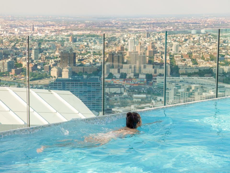 The author swims with the NYC skyline in the background.