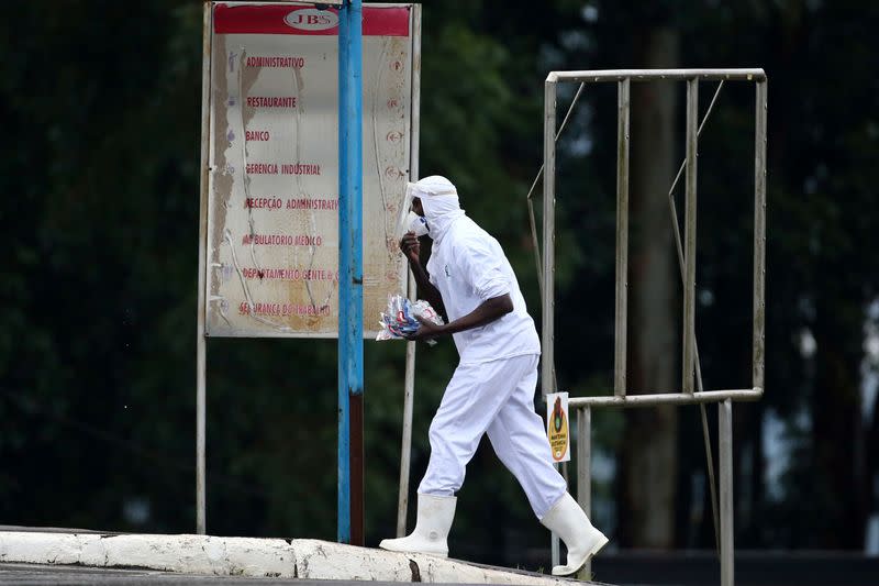 An employee of the JBS SA poultry factory walks after the company was hit by an outbreak of the coronavirus disease (COVID-19), in Passo Fundo