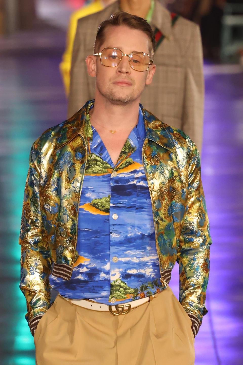 Macaulay walking down the runway to model for Gucci