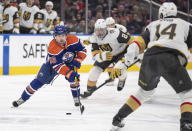 Vegas Golden Knights' Zach Whitecloud (2) and Nicolas Hague (14) chase Edmonton Oilers' Kailer Yamamoto (56) during the second period of an NHL hockey game Saturday, March 25, 2023, in Edmonton, Alberta. (Jason Franson/The Canadian Press via AP)