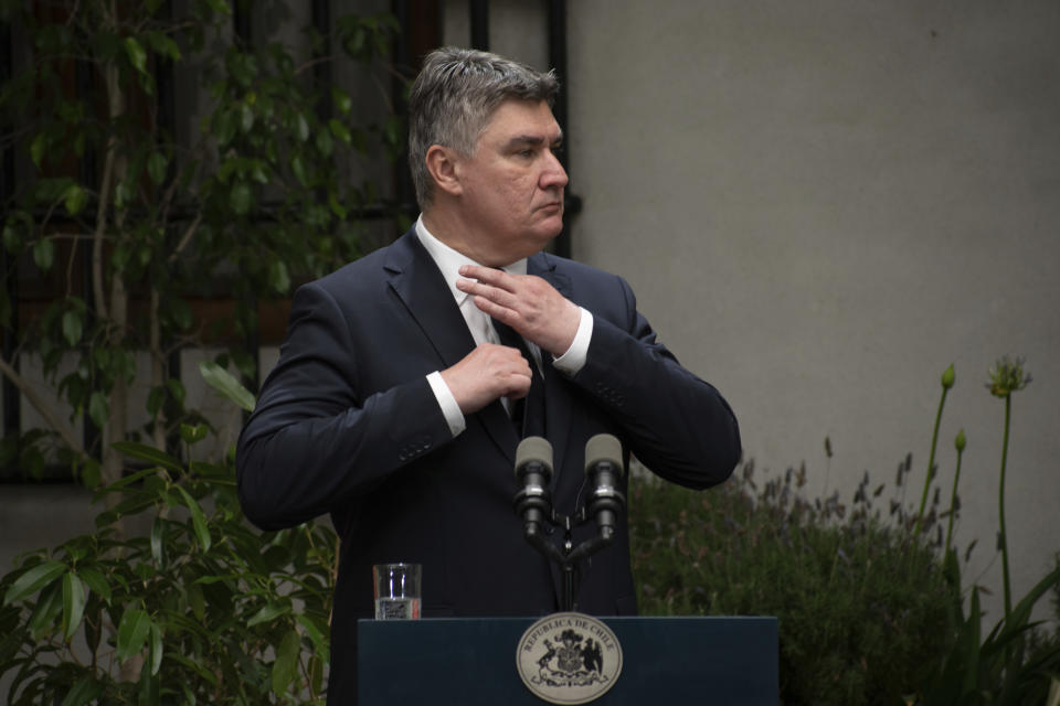 FILE - Croatia's President Zoran Milanovic adjusts his tie at a press conference with Chilean President Gabriel Boric at La Moneda Presidential palace in Santiago, Chile, on Dec. 12, 2022. Milanovic cannot run for prime minister nor take part in the upcoming parliamentary election nor campaign in favor of an opposition party unless he resigns immediately from the current post, the state’s constitutional court ruled Monday, March 18, 2024. (AP Photo/Matias Basualdo, File)