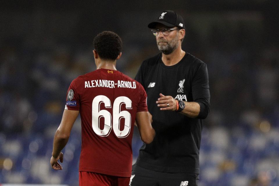 Liverpool's manager Jurgen Klopp, right, shake shards with Trent Alexander-Arnold reacts after the Champions League Group E soccer match between Napoli and Liverpool, at the San Paolo stadium in Naples, Italy, Tuesday, Sept. 17, 2019. Napoli won 2-0. (AP Photo/Gregorio Borgia)