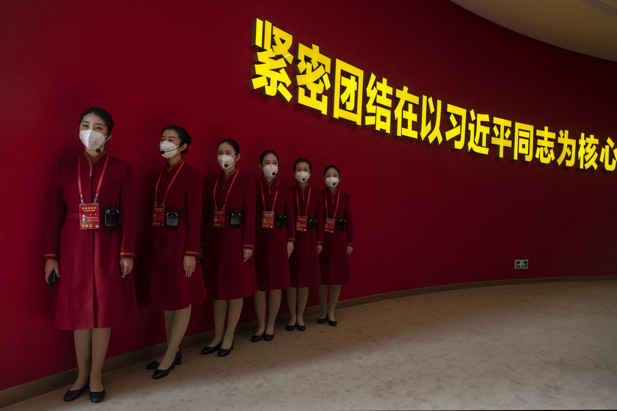 Hostesses at an exhibition highlighting Xi's years as leader