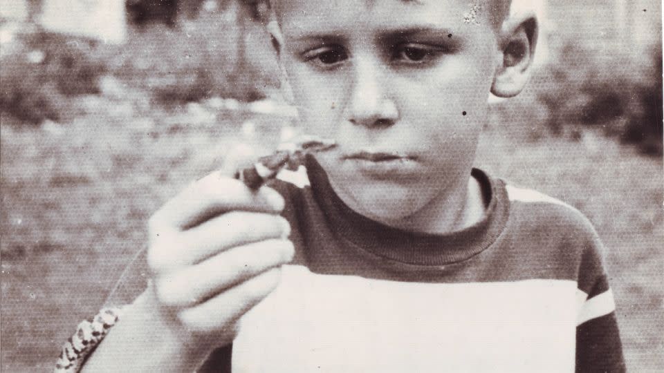 A young Romulus Whitaker holds up a milk snake circa 1947 in Hoosick, New York. - Doris Norden