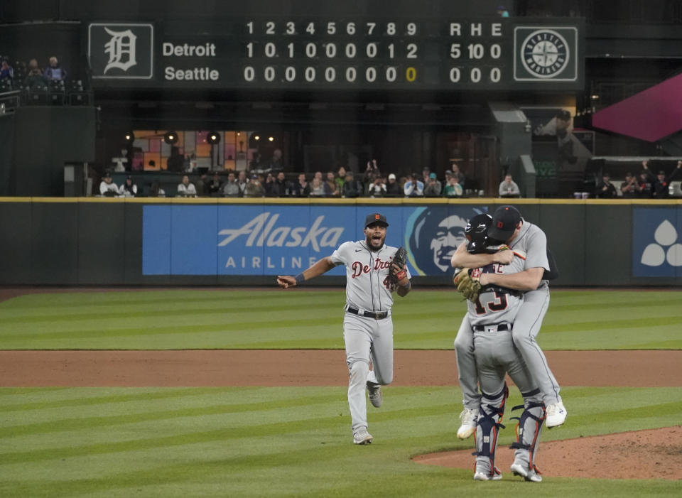 Detroit Tigers starting pitcher Spencer Turnbull, right, hugs catcher Eric Haase as third baseman Jeimer Candelario rushes to join them after Turnbull threw a no-hitter in the team's baseball game against the Seattle Mariners, Tuesday, May 18, 2021, in Seattle. The Tigers won 5-0. (AP Photo/Ted S. Warren)