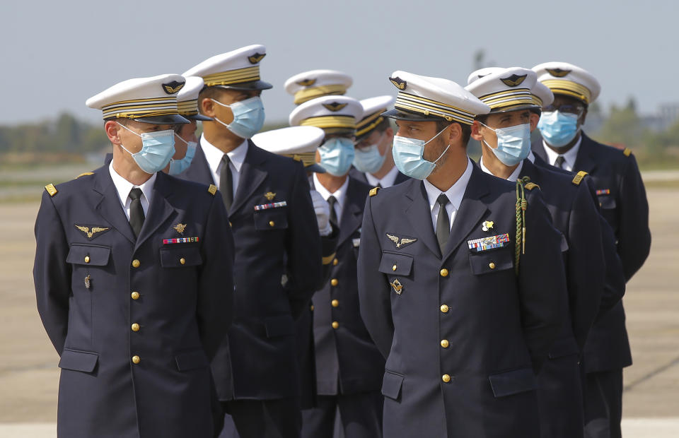 French Air Force officers wearing protective face masks as precaution against the conoravirus await French Defense Minister Florence Parly during a ceremony at the airbase of Villacoublay, west of Paris, Friday, Sept. 11, 2020. France has seen a sharp uptick in new Covid cases in recent weeks. (AP Photo/Michel Euler)