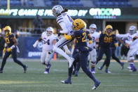 Kansas State wide receiver Malik Knowles is defended by West Virginia defensive back Jacolby Spells (28) during the first half of an NCAA college football game in Morgantown, W.Va., Saturday, Nov. 19, 2022. (AP Photo/Kathleen Batten)