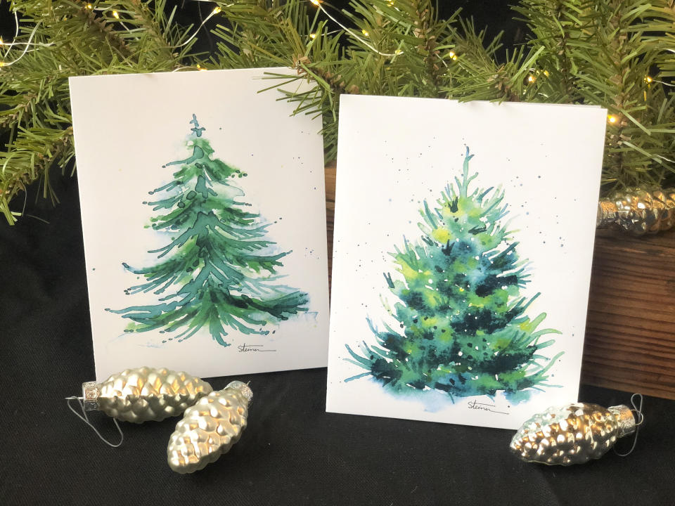 This image provided by Judy A. Steiner shows handmade watercolor Christmas tree cards. Handmade holiday cards can be gifts in themselves for both maker and receiver. They're a way to express creativity and connection. And gathering to make them can be a nice social activity. (Judy A. Steiner via AP)